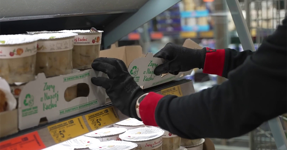 Shop employee picking paper packaging from a shelf (photo)