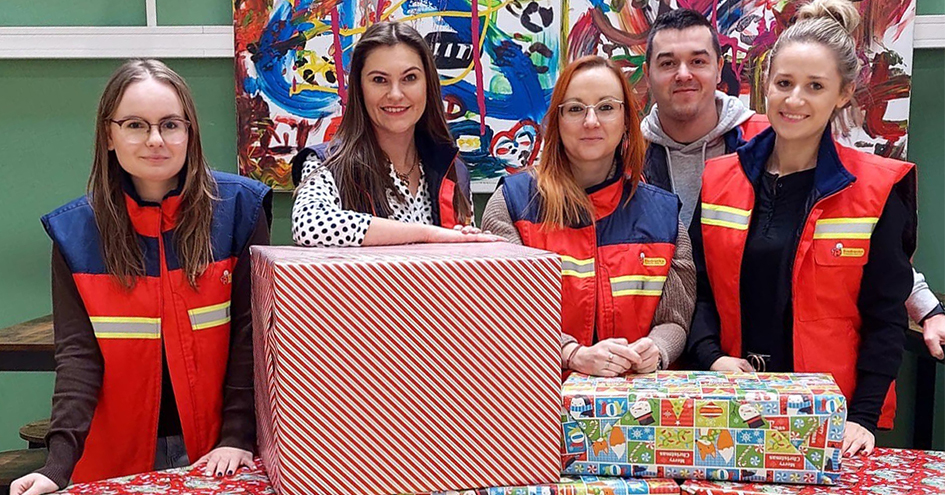 Group of five people with two big packaged gifts for vulnerable people (photo)