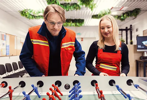 Two Biedronka employees, a man and a woman, playing table football (photo)