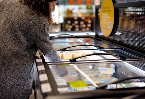 A customer taking a product from a store refrigerator (photo)
