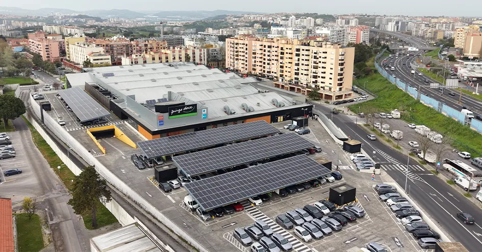 Aerial shot of a Pingo Doce with solar panels on the roofs in the parking lot (photo)