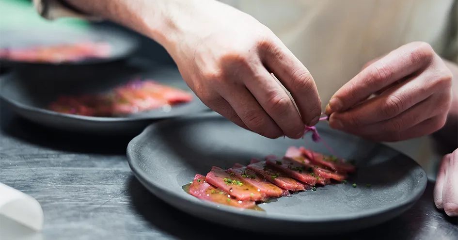 Close-up of sashimi being plated (photo)