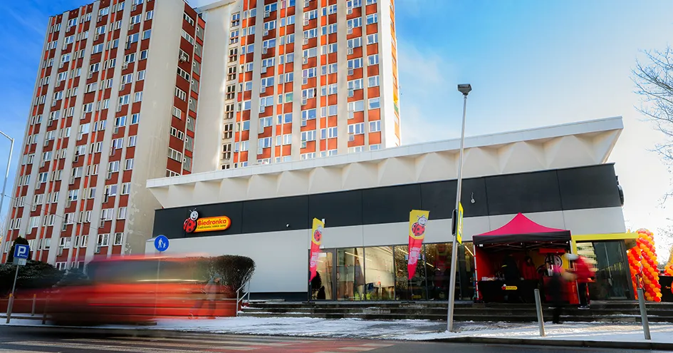 Fachada de uma loja Biedronka com um prédio de apartamentos atrás (foto)